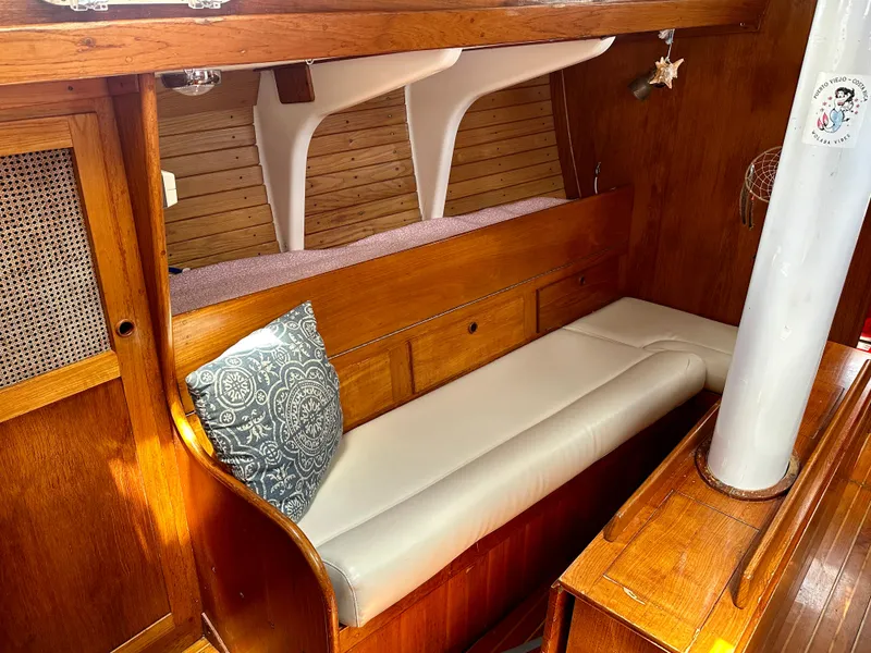 Slide: The Image of Interior of 1980 Alden 44 sailboat with wooden finish and cushioned seating. - 21