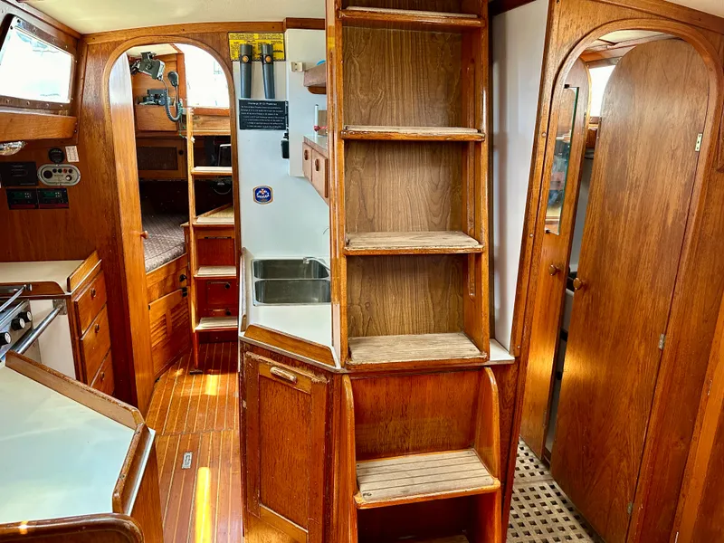 Slide: The Image of Interior of 1980 Alden 44 sailboat with wooden cabinetry and compact kitchen. - 25