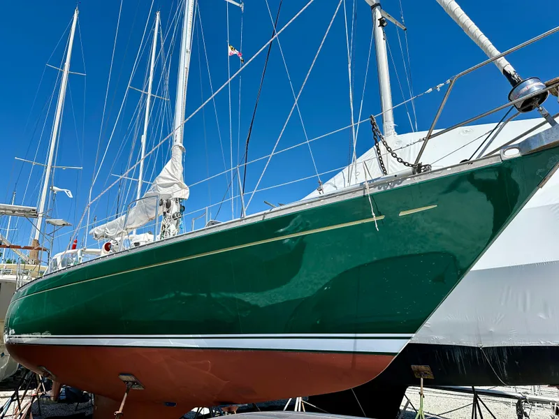 Slide: The Image of 1980 Alden 44 sailboat with green hull and white trim in dry dock. - 4