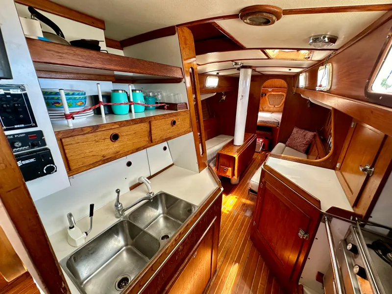 Slide: The Image of 1980 Alden 44 yacht interior with wooden cabinetry and dual sink in the galley. - 8