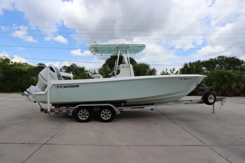 Slide: The Image of 2012 Contender 25 Tournament boat on trailer, side view, outdoors. - 0