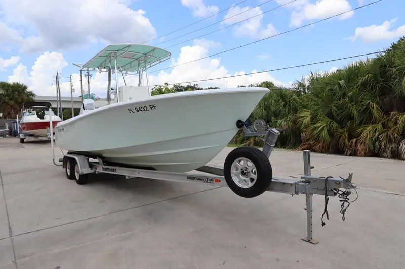 Slide: The Image of 2012 Contender 25 Tournament boat on trailer, parked outdoors. - 4