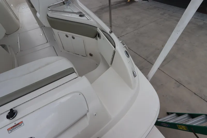 Slide: The Image of 2007 Sea Ray 240 Sundeck boat interior, white seating, storage compartments. - 15
