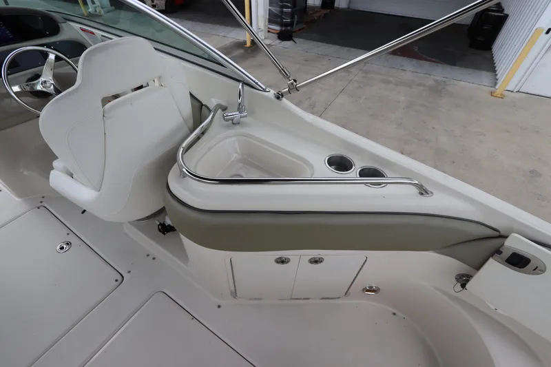 Slide: The Image of 2007 Sea Ray 240 Sundeck interior with helm seat and sink. - 18