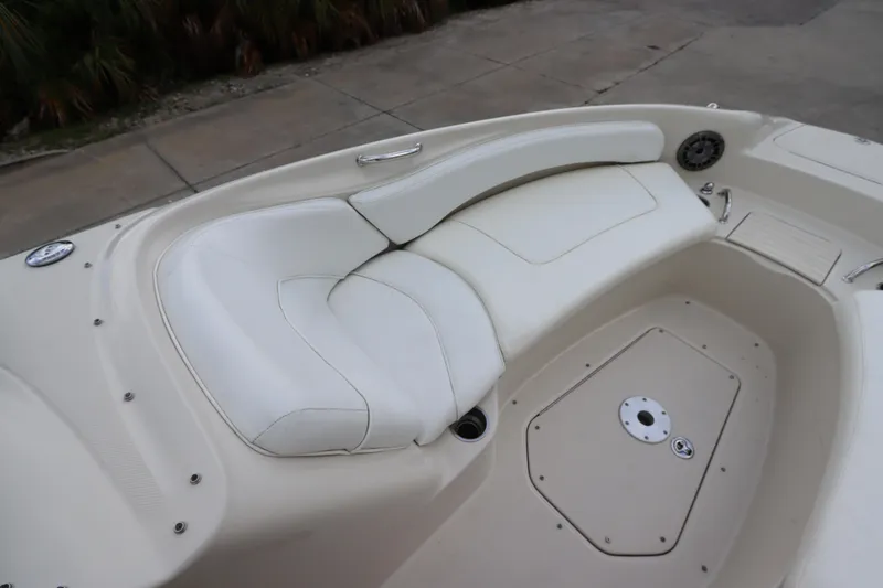 Slide: The Image of 2007 Sea Ray 240 Sundeck boat with white cushioned seating area. - 32