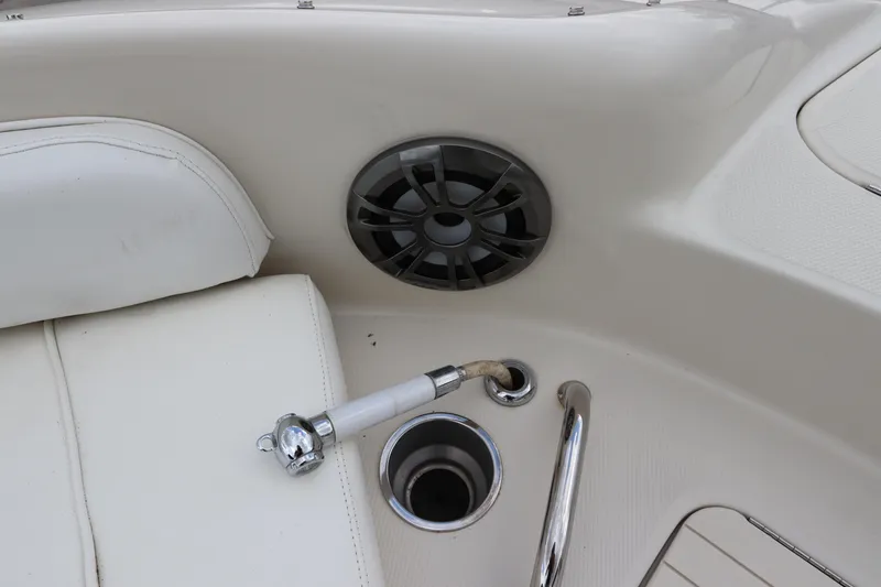 Slide: The Image of 2007 Sea Ray 240 Sundeck interior, featuring a speaker, cup holder, and seat. - 34