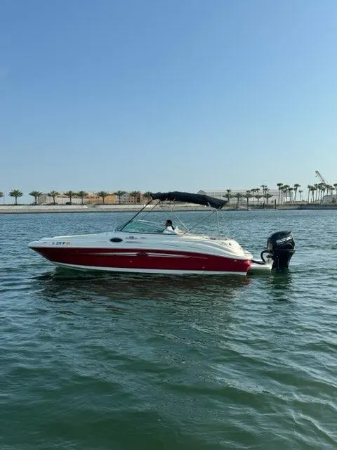 Slide: The Image of 2007 Sea Ray 240 Sundeck boat on calm water with a clear sky. - 4