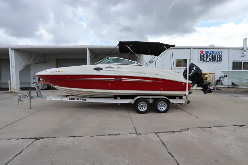 Slide: The Image of 2007 Sea Ray 240 Sundeck boat on a Continental trailer in a marina. - 5