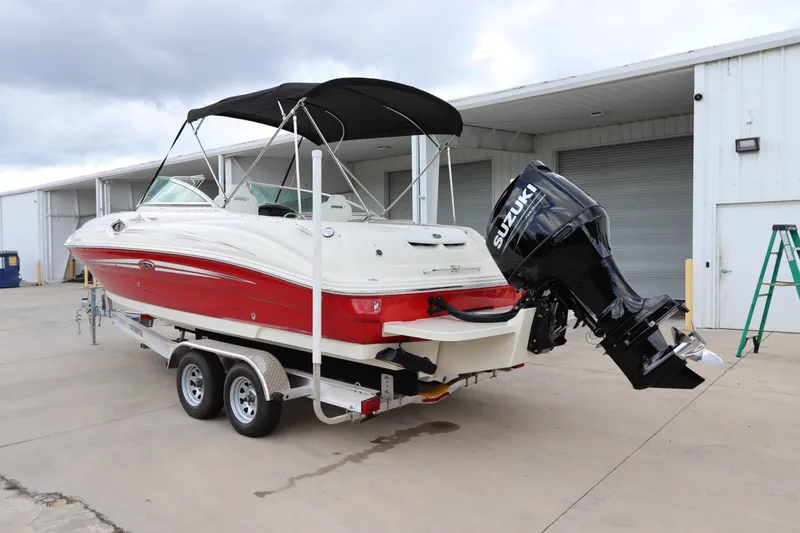 Slide: The Image of 2007 Sea Ray 240 Sundeck boat on trailer with Suzuki outboard motor. - 9