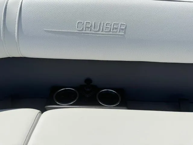Slide: The Image of 2024 Harris Cruiser 230 boat interior with cup holders and embossed Cruiser logo. - 11