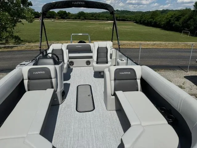 Slide: The Image of 2024 Harris Cruiser 230 pontoon boat with spacious seating and modern design. - 4
