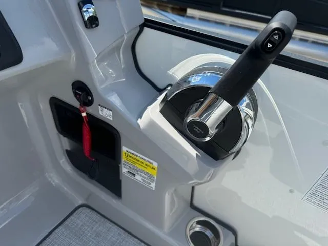 Slide: The Image of 2024 Harris Cruiser 230 boat control panel with throttle and safety lanyard. - 6