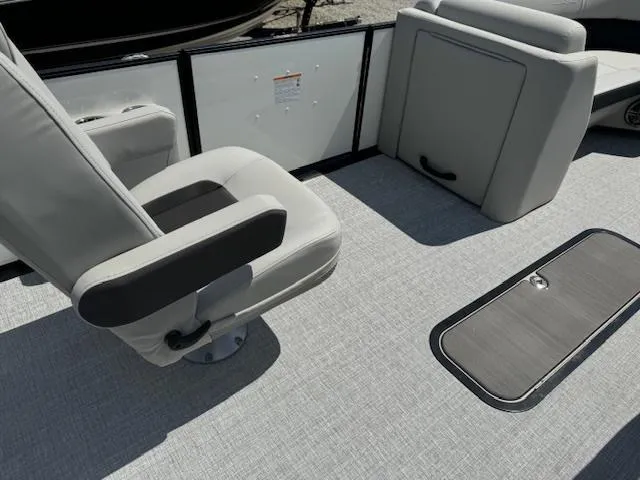 Slide: The Image of 2024 Harris Cruiser 230 boat interior with gray seating and flooring. - 7