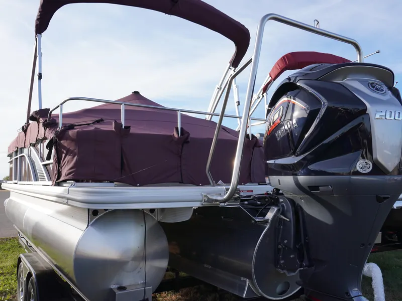 Slide: The Image of 2024 Bennington 22SXSB pontoon boat with Yamaha 200 engine, covered and docked. - 1