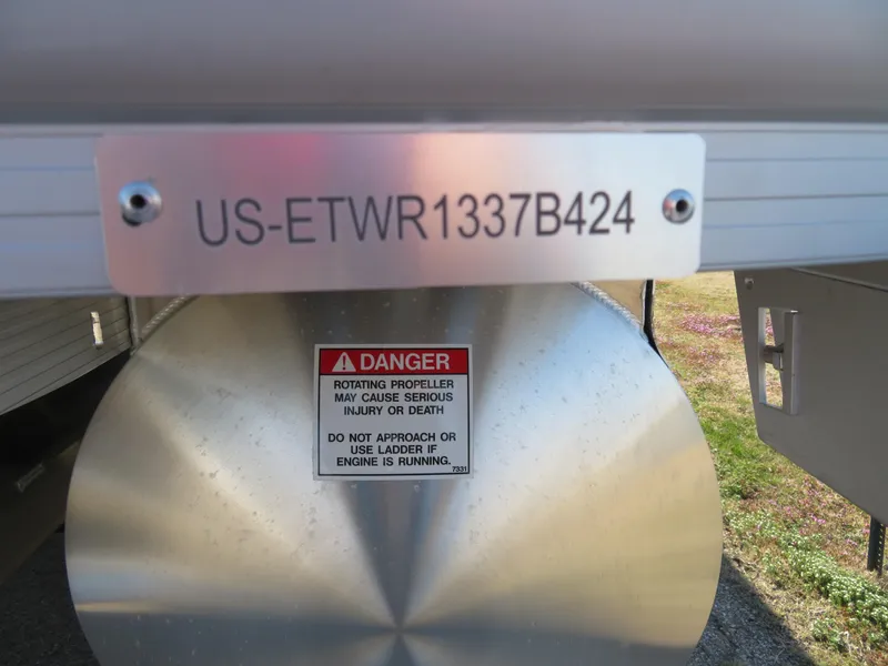 Slide: The Image of 2024 Bennington 22SXSB boat with safety warning and serial number plate. - 3