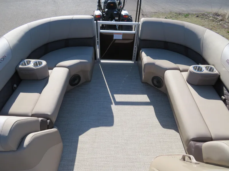 Slide: The Image of 2024 Bennington 22SXSB pontoon boat interior with beige seating and cup holders. - 9