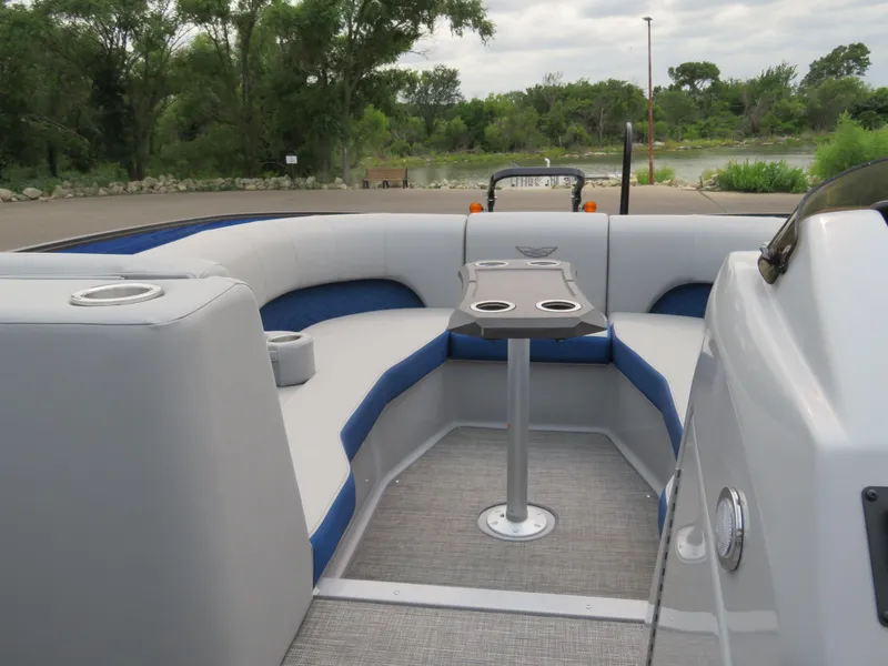 Slide: The Image of 2024 Bennington 25LTSB boat interior with cushioned seating and table. - 20