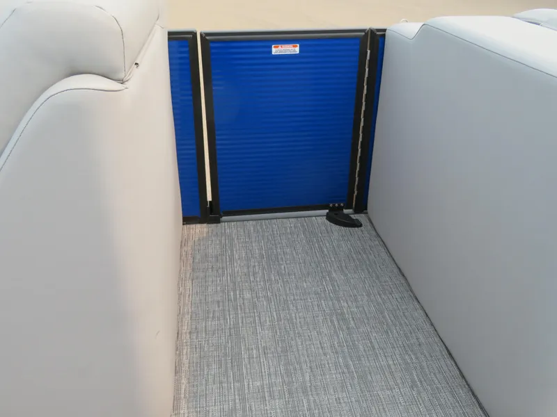 Slide: The Image of 2024 Bennington 25LTSB boat interior with blue gate and grey flooring. - 21