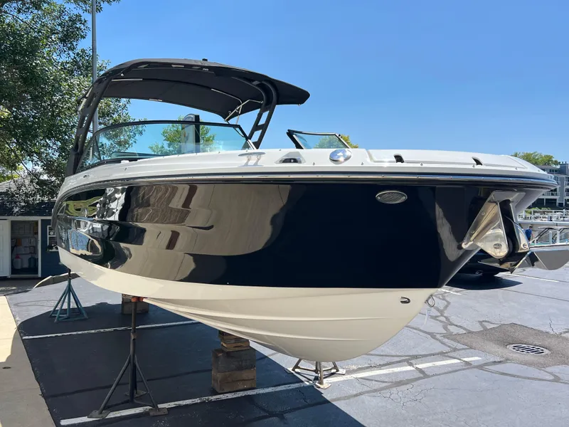 Slide: The Image of 2025 Sea Ray SDX 270 boat on display at a marina. - 1
