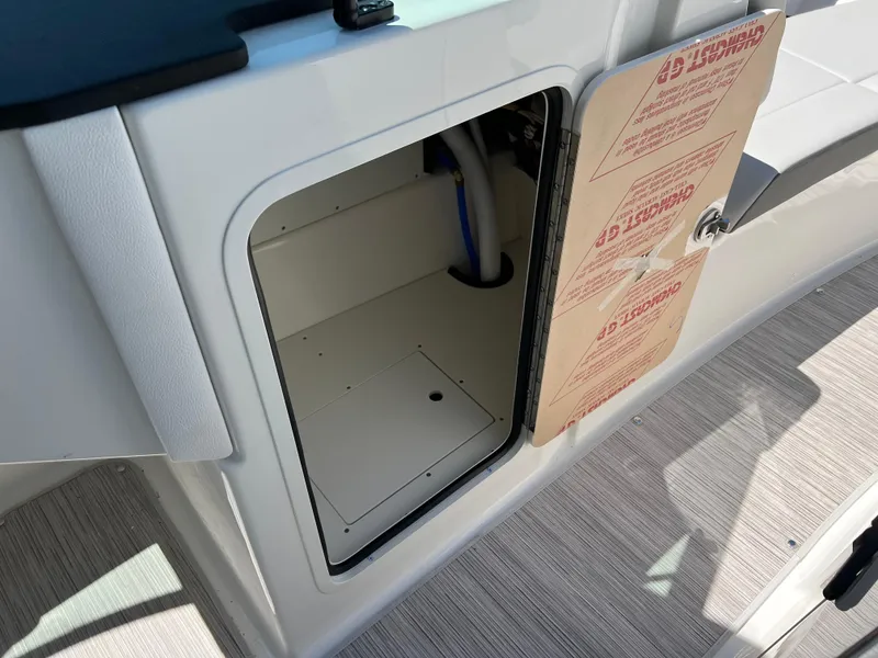 Slide: The Image of Open storage compartment on a 2025 Sea Ray SDX 270 boat. - 10