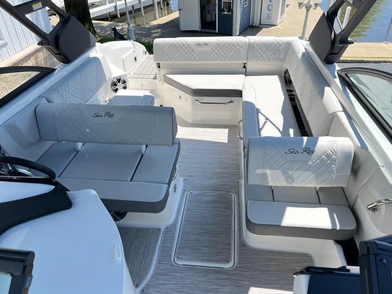 Slide: The Image of 2025 Sea Ray SDX 270 boat interior with white seating and spacious layout. - 12