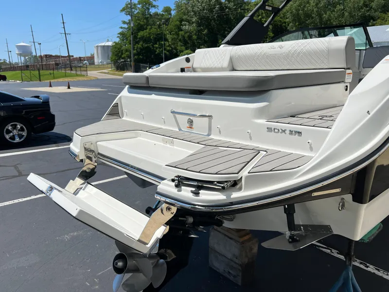 Slide: The Image of 2025 Sea Ray SDX 270 boat stern with swim platform and outboard motor. - 14