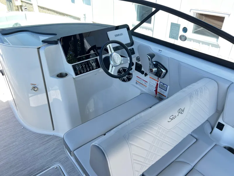 Slide: The Image of 2025 Sea Ray SDX 270 boat cockpit with modern steering and seating. - 5