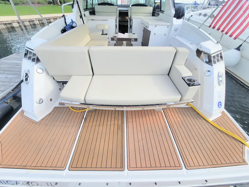 Slide: The Image of 2017 Monterey 360 Sport Coupe boat with spacious seating and teak deck, docked in Chicago. - 12