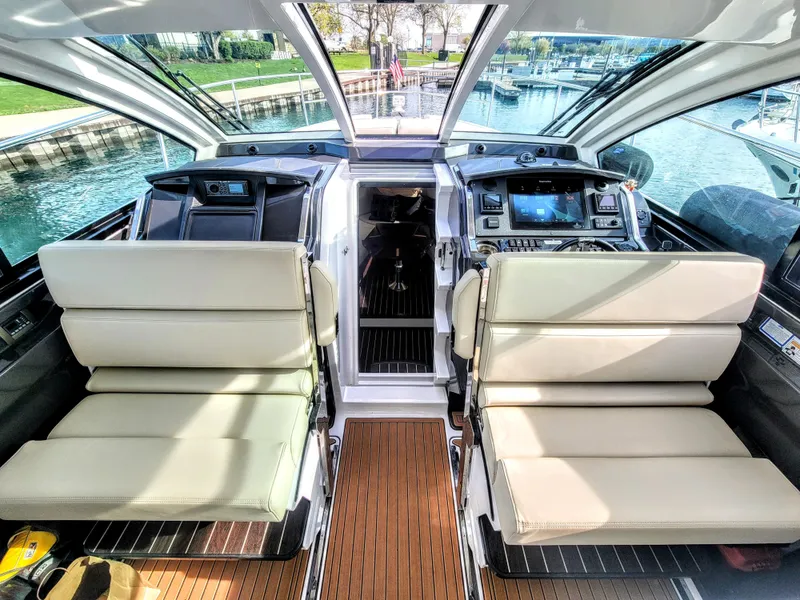 Slide: The Image of Interior of 2017 Monterey 360 Sport Coupe yacht with luxurious seating and modern dashboard. - 16