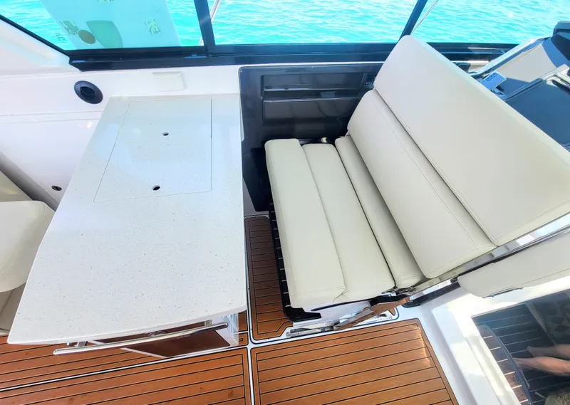 Slide: The Image of Luxurious seating and table on 2017 Monterey 360 Sport Coupe yacht interior. - 17