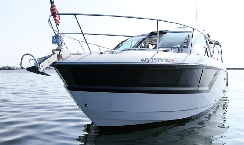 Slide: The Image of 2017 Monterey 360 Sport Coupe boat on calm water, front view. - 2
