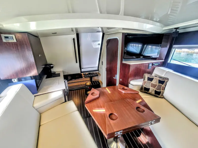 Slide: The Image of Interior of a 2017 Monterey 360 Sport Coupe yacht with modern seating and wooden table. - 27