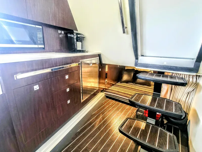 Slide: The Image of 2017 Monterey 360 Sport Coupe interior with modern kitchen and cozy seating area. - 28