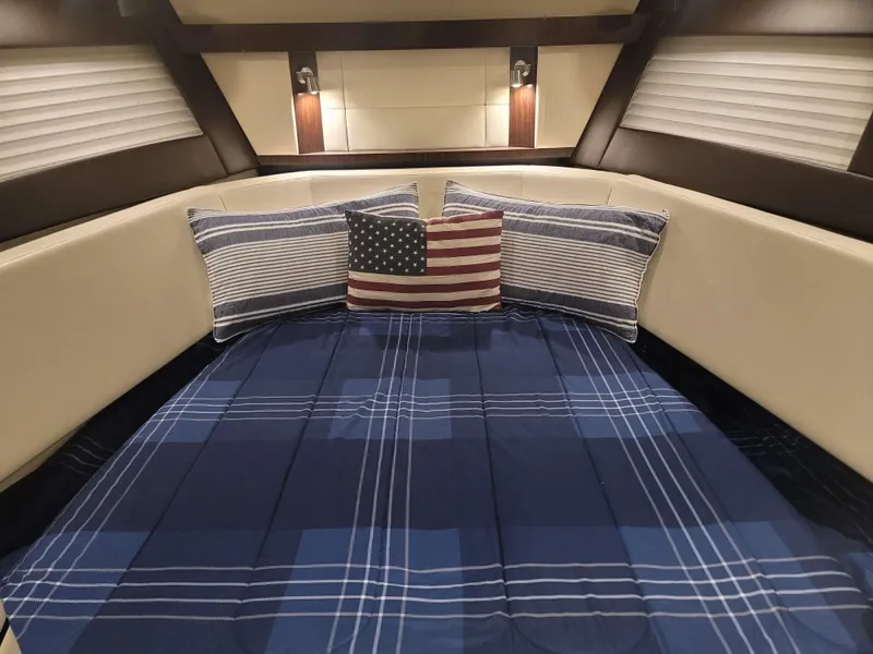 Slide: The Image of Cozy cabin interior of 2017 Monterey 360 Sport Coupe with plaid bedding and decorative pillows. - 29