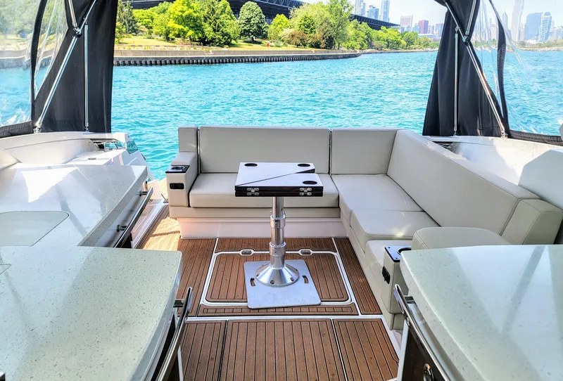 Slide: The Image of 2017 Monterey 360 Sport Coupe interior with seating, table, and scenic water view. - 6