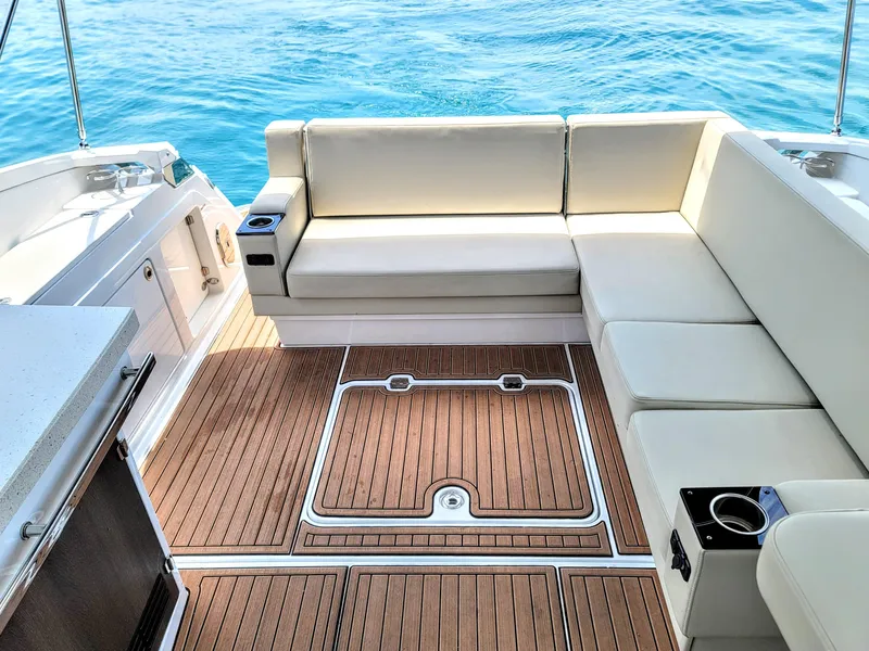 Slide: The Image of Luxurious seating area on a 2017 Monterey 360 Sport Coupe yacht with teak flooring. - 9