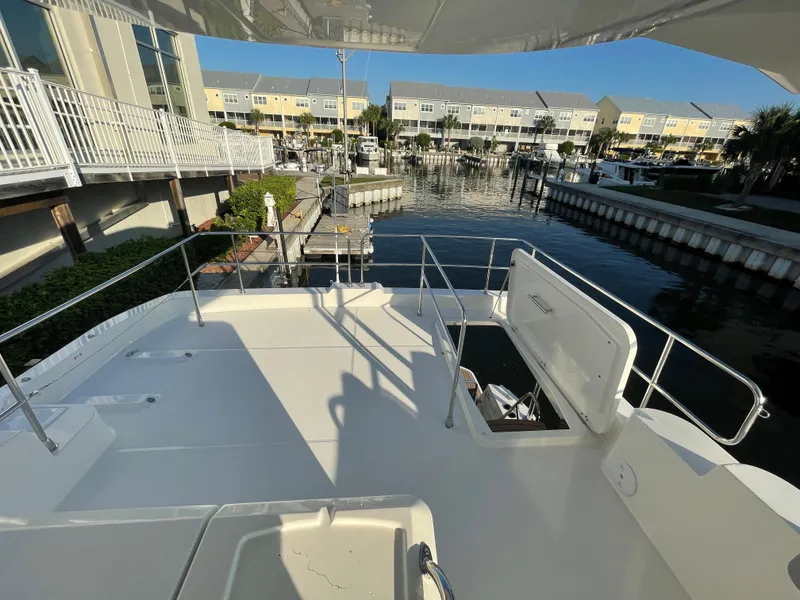 Slide: The Image of Beneteau Swift Trawler 48 (2025) docked, spacious deck view with marina background. - 23