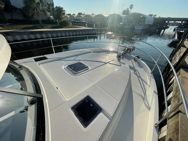 Slide: The Image of 2025 Beneteau Swift Trawler 48 bow view at marina dock. - 24