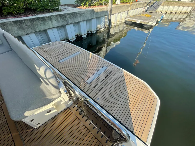 Slide: The Image of Beneteau Swift Trawler 48 (2025) swim platform with teak decking at a marina. - 31