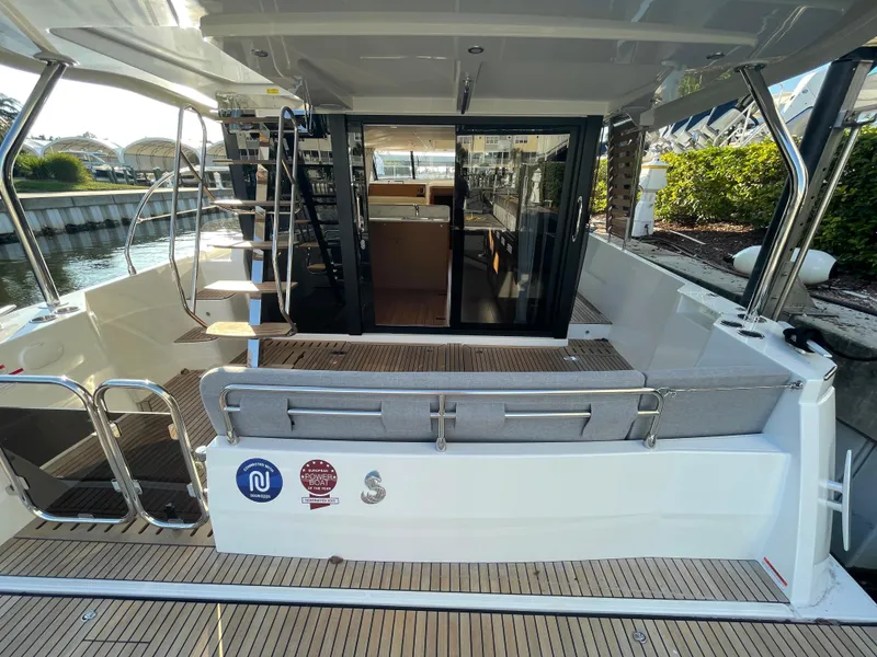 Slide: The Image of 2025 Beneteau Swift Trawler 48 rear deck with seating and waterway view. - 32