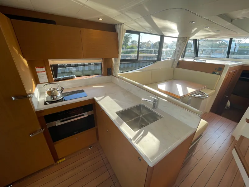 Slide: The Image of Modern kitchen and dining area in 2025 Beneteau Swift Trawler 48 yacht. - 34