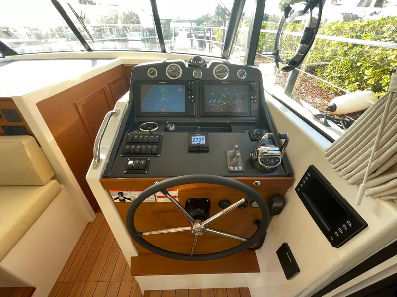 Slide: The Image of Helm station of 2025 Beneteau Swift Trawler 48 with modern navigation equipment. - 38