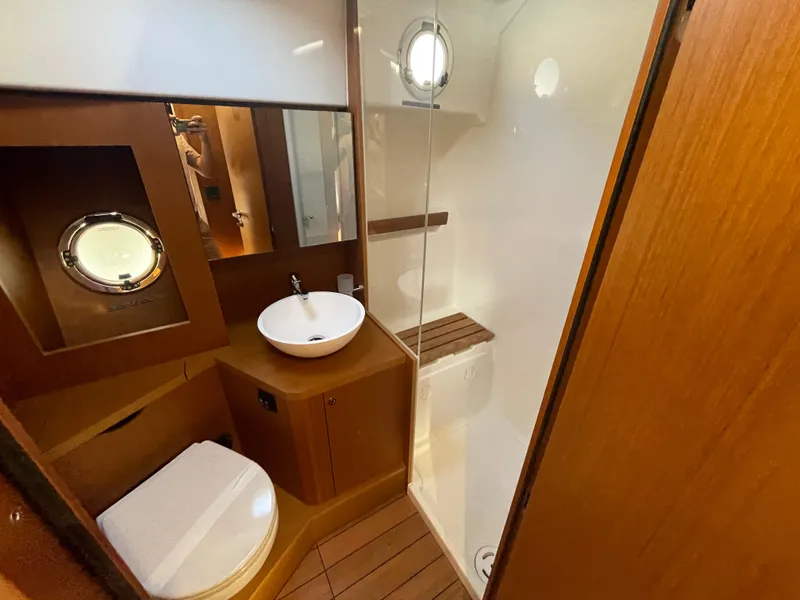 Slide: The Image of 2025 Beneteau Swift Trawler 48 bathroom with modern fixtures and wooden accents. - 47