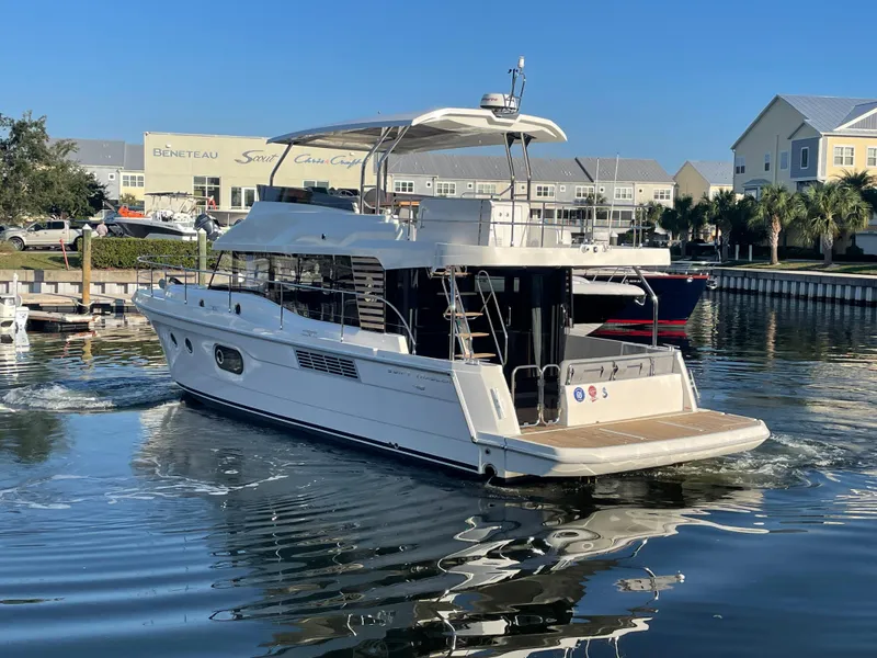 Slide: The Image of 2025 Beneteau Swift Trawler 48 docked in a marina. - 8