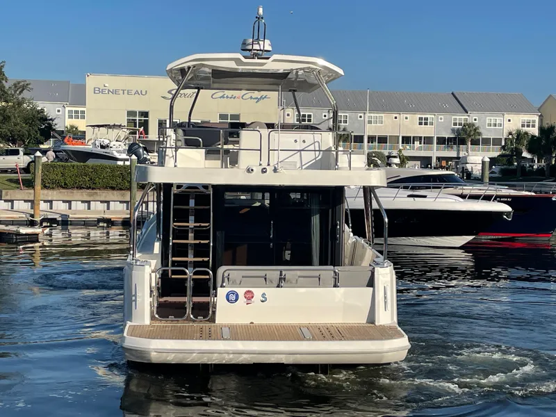 Slide: The Image of 2025 Beneteau Swift Trawler 48 docked at marina, rear view. - 9