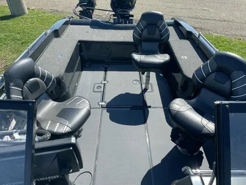 Slide: The Image of 2022 Nitro ZV21 fishing boat with four black seats and spacious deck. - 7