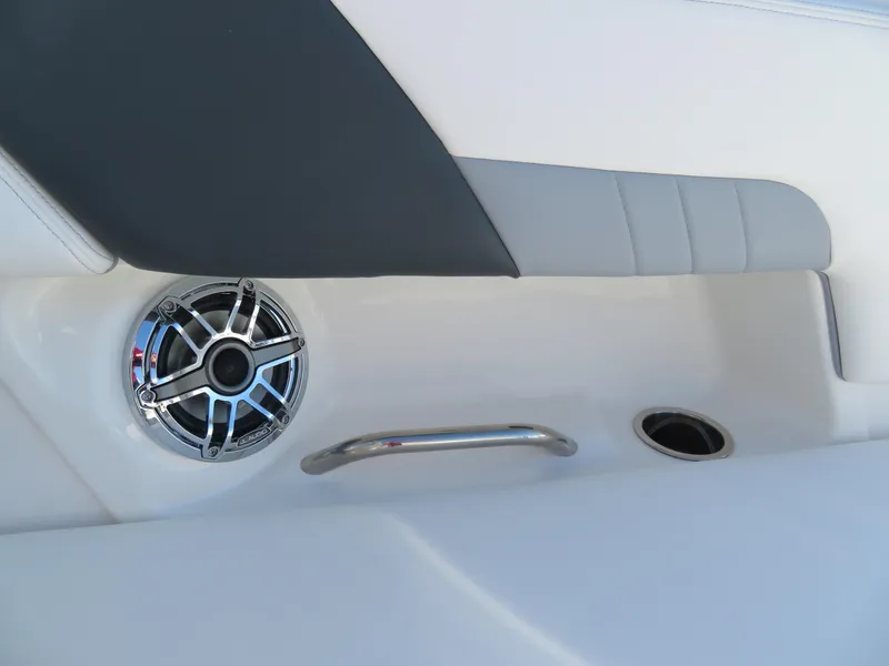Slide: The Image of 2024 Chaparral 23 Surf boat interior with speaker and handrail. - 11