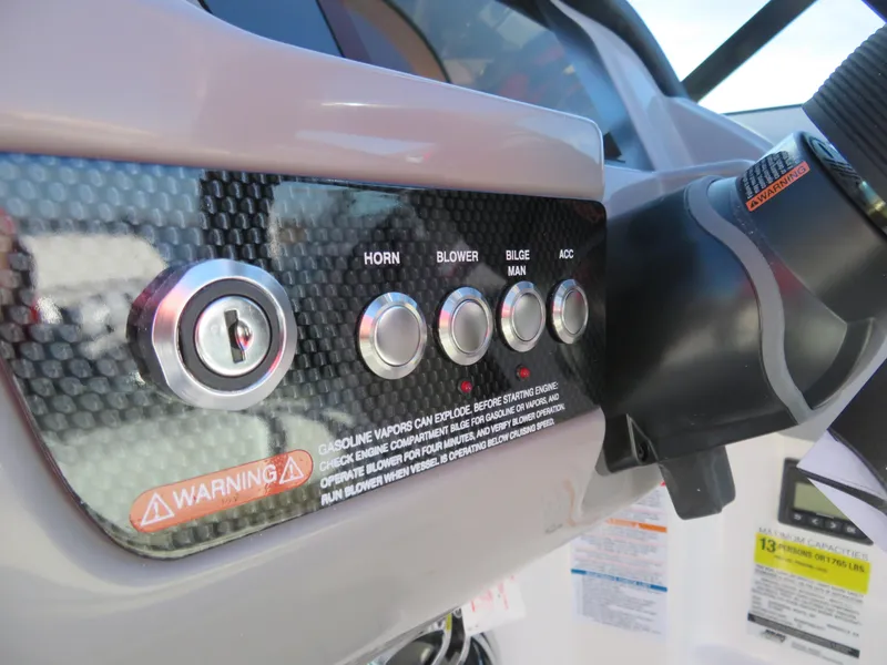 Slide: The Image of Control panel of 2024 Chaparral 23 Surf boat with ignition and function buttons. - 14