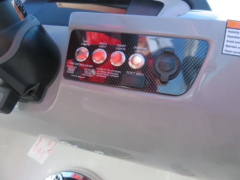 Slide: The Image of Control panel of 2024 Chaparral 23 Surf boat with various switches and 12V outlet. - 15