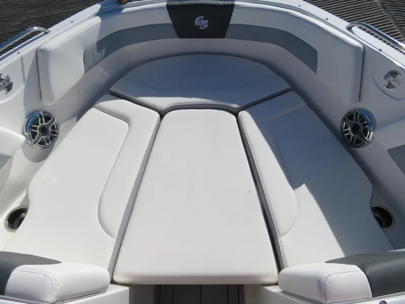 Slide: The Image of 2024 Chaparral 23 Surf boat interior with cushioned seating and built-in speakers. - 17